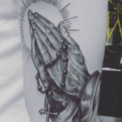 Руки молящегося с крестом  на плече (на руке)