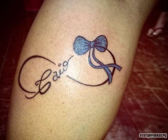 Фотография татуировки под названием «Бесконечность с бантом и надписью»