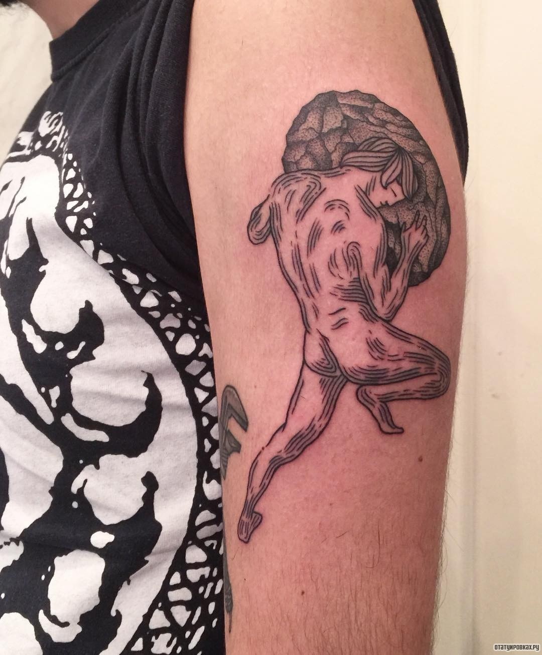 Фотография татуировки под названием «Человек с камнем»
