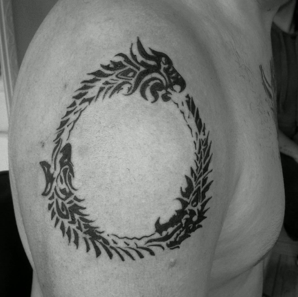 Кельтский стиль татуировки уроборос на плече