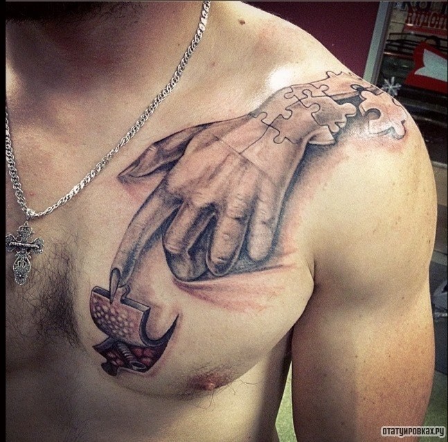 Фотография татуировки под названием «Рука пазлы»