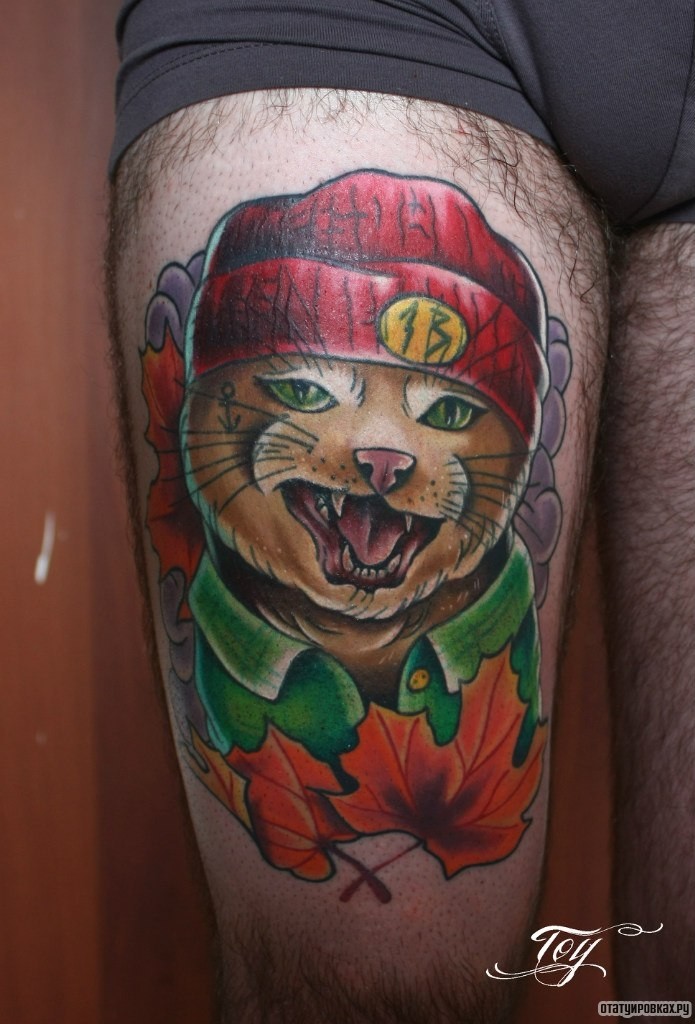 Фотография татуировки под названием «Довольный кот в красной шапке»
