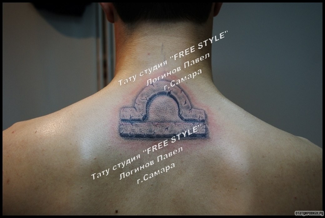 Фотография татуировки под названием «Символ на спине парня»