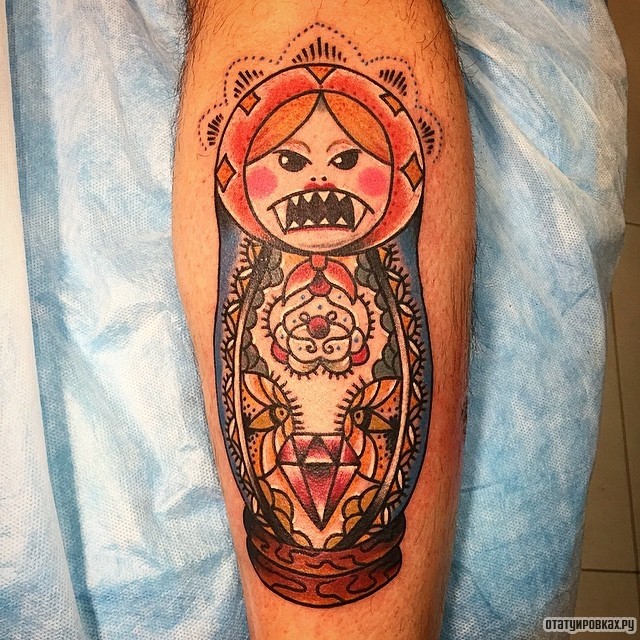 Фотография татуировки под названием «Матрешка со страшными зубами»