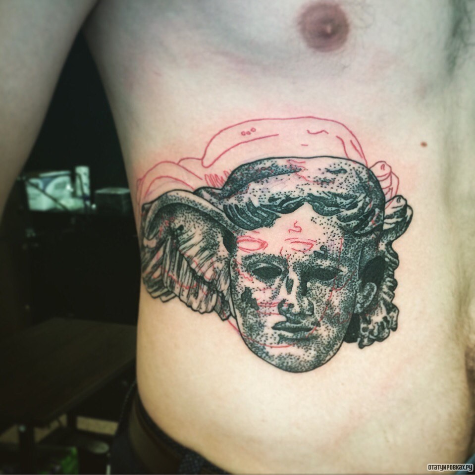 Фотография татуировки под названием «Лицо человека»